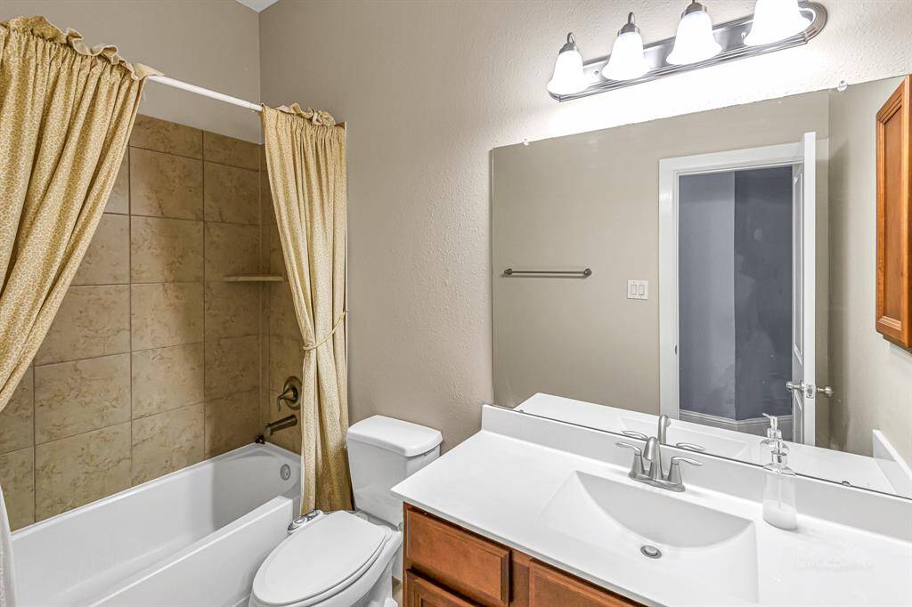 Hall bath serves both secondary bedrooms.