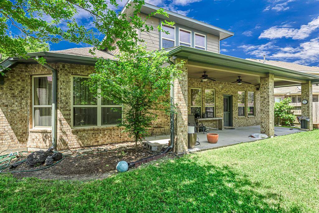Lush grounds surround the patio.