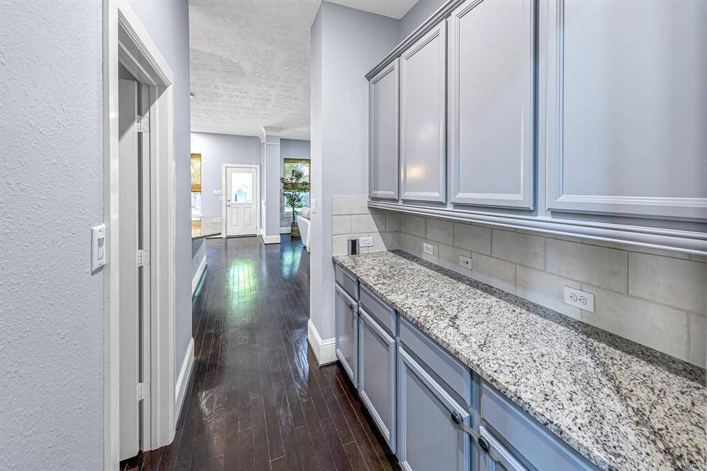 The butlers pantry provides generous storage options and functional countertop.