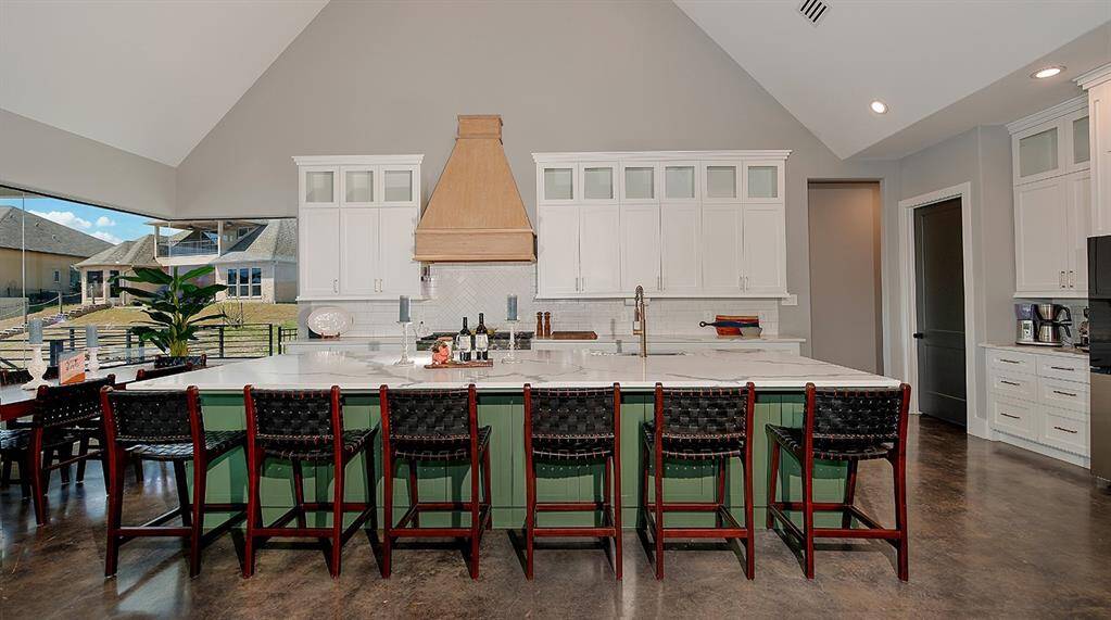 Gorgeous custom cabinetry, white oak vent hood and quartz counters throughout.