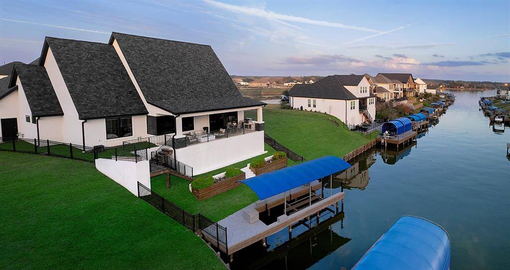 Recently added boat dock, boat lift with bikini top and stairway with retaining wall leading you to and from the patio.