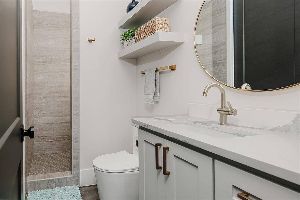 Third full secondary bathroom with quartz counters and walk-in shower.