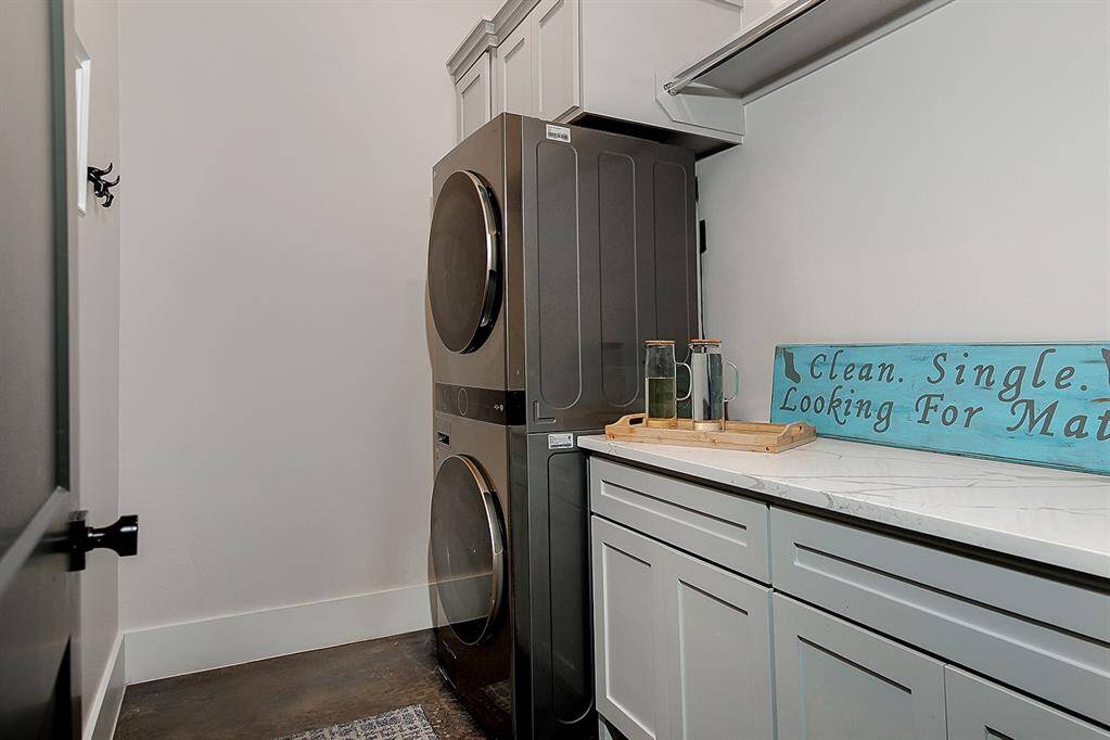 Laundry room with counter space and cabinetry for storage.