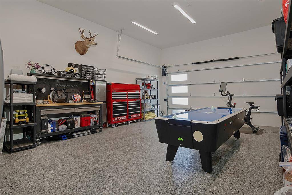 The climate controlled, fully insulated garage with epoxy flooring allows for the perfect workshop or workout space. The builder also added another 800-900 SqFt upstairs if buyer wishes to complete. The attic is huge!