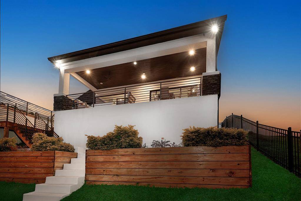 Elegant planter boxes surround the back of the home along with wrought iron fence so your furry friends don't escape!