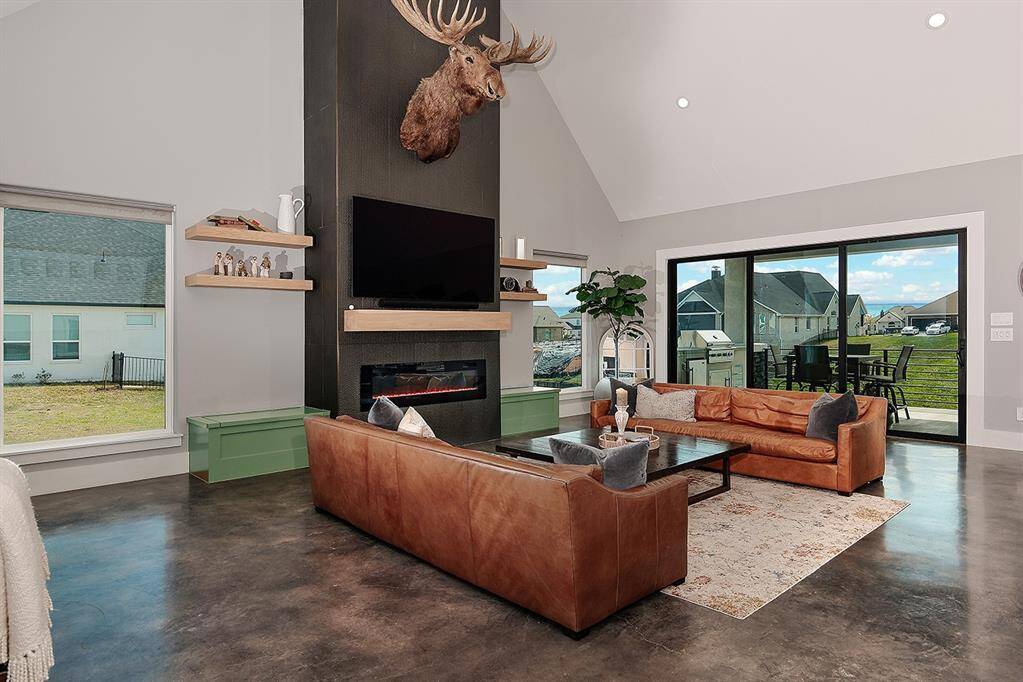 The living rooms is lined in windows allowing for amazing lake views from all angles.