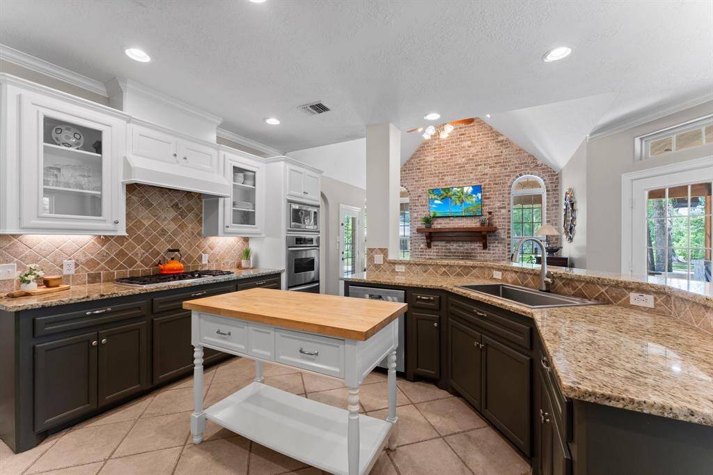 The kitchen overlooking the family room. This kitchen's design is timeless and features gas cooktop, large sink and stainless appliances.