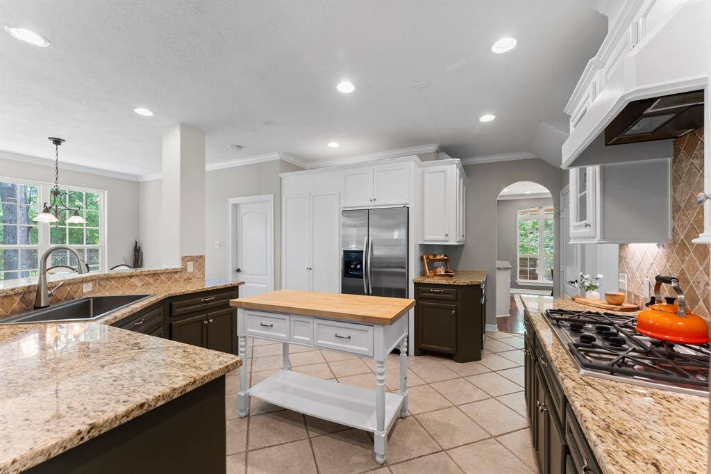 Breakfast nook to the left, closed door leading to the utility room and opening leads to the fine dining space.