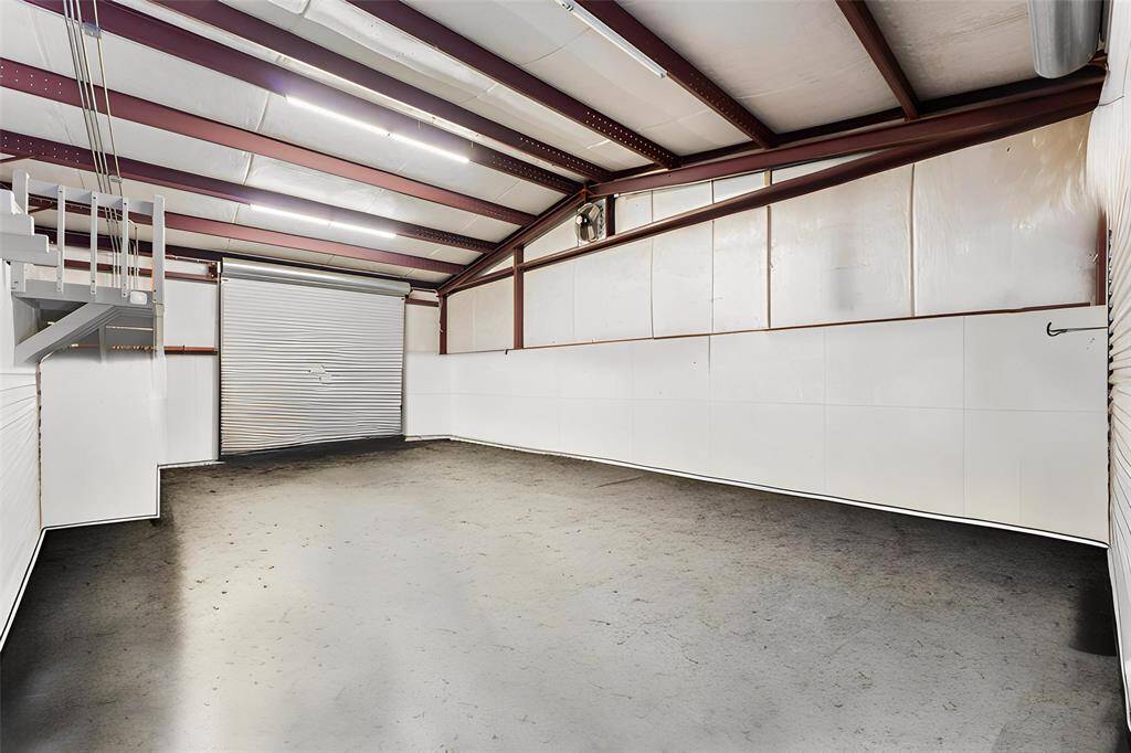 Inside shop #1 that is attached to the casita. Notice the two automatic large roll up doors!  Two story storage!