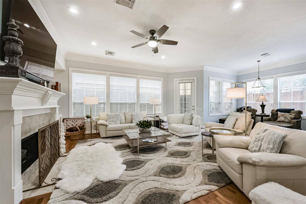 Bright and inviting living area filled with natural light , featuring a cozy gas log fireplace as the perfect focal point.
