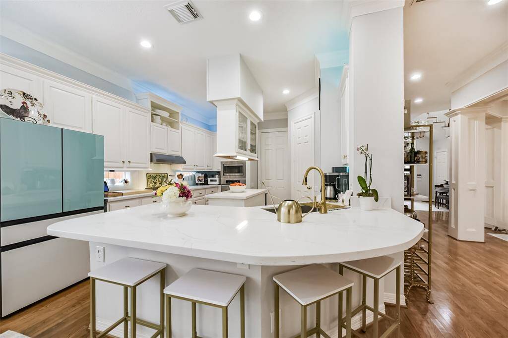 Quartz counter tops , Glass back splash , Samsung glass front refrigerator, design color lighting over cabinet's.