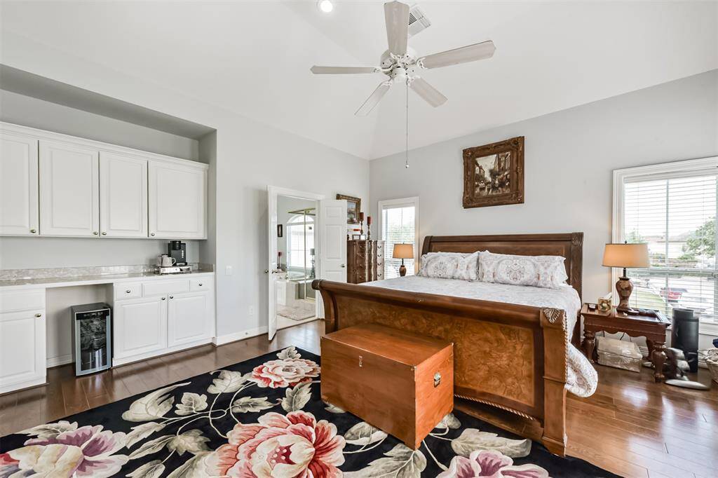 Spacious upstairs primary bedroom offers a peaceful private retreat, with plenty of room. Even an area for a coffee bar and added storage.