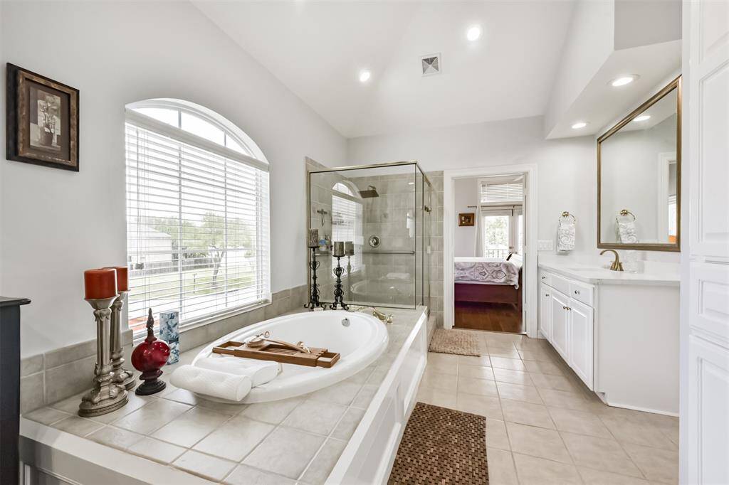 Expansive and luxurious primary bath including a large jet tub a separate walk-in-shower for ultimate relaxation and spa-like comfort.