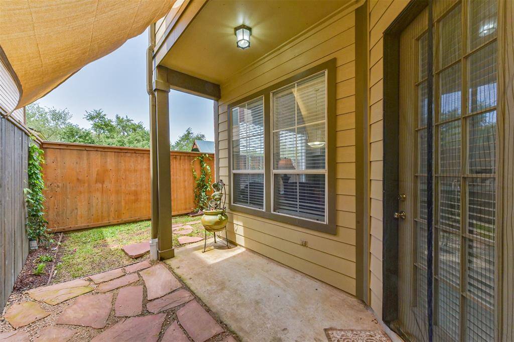Back porch and a side yard with stone path access to front.