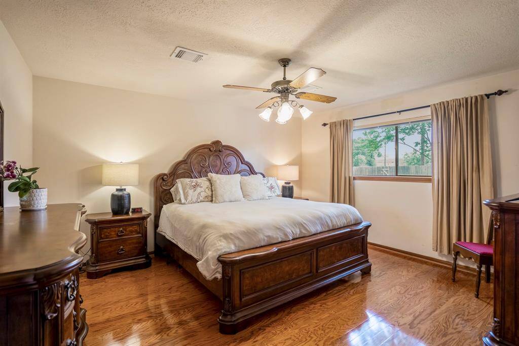 Primary Bedroom on the first floor features wood floor, neutral paint and natural light.