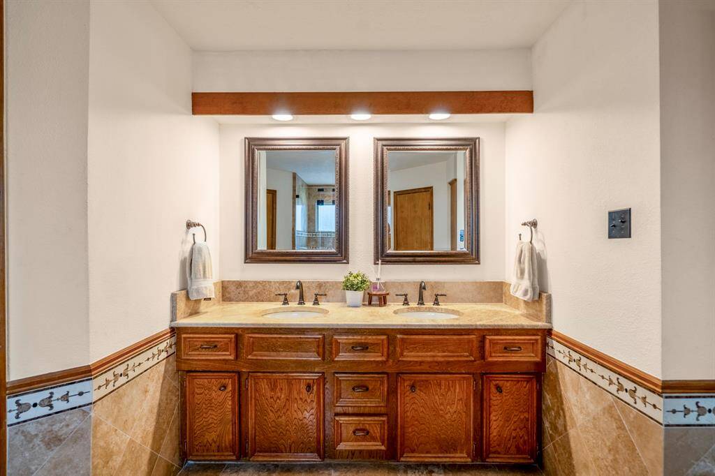 Primary Bath double sinks and cabinetry for storage.