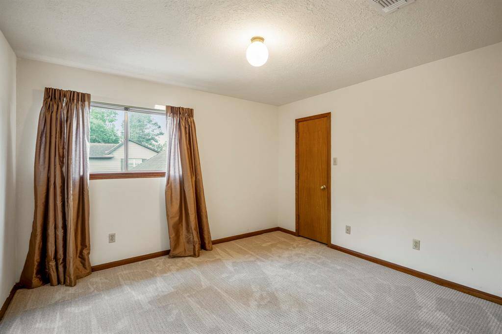 Secondary upstairs Bedroom with carpet and a ceiling fan