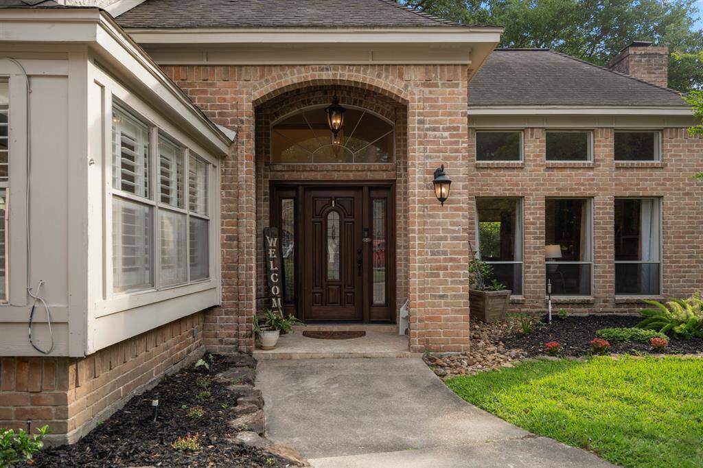 Covered Entry leading to a solid wood front door and quaint front porch.
