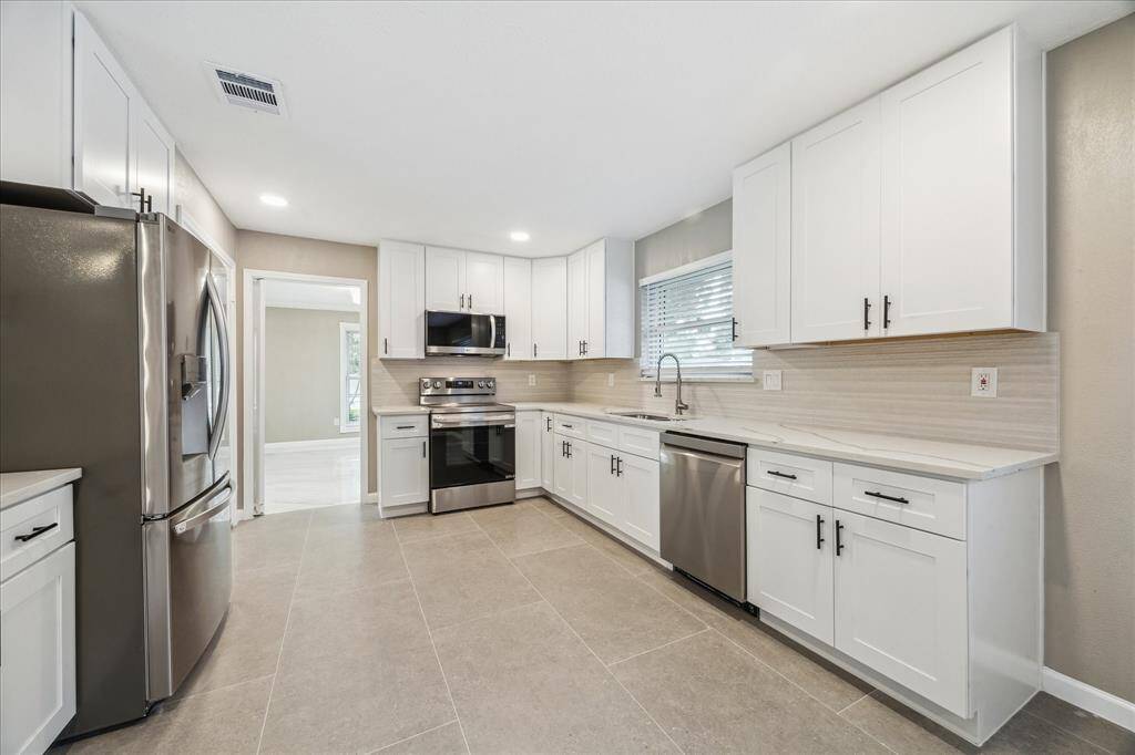 VIEW OF KITCHEN FROM LAUNDRY ROOM AND GARAGE