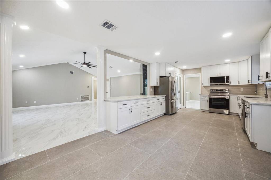 VIEW OF KITCHEN AND LIVING ROOM