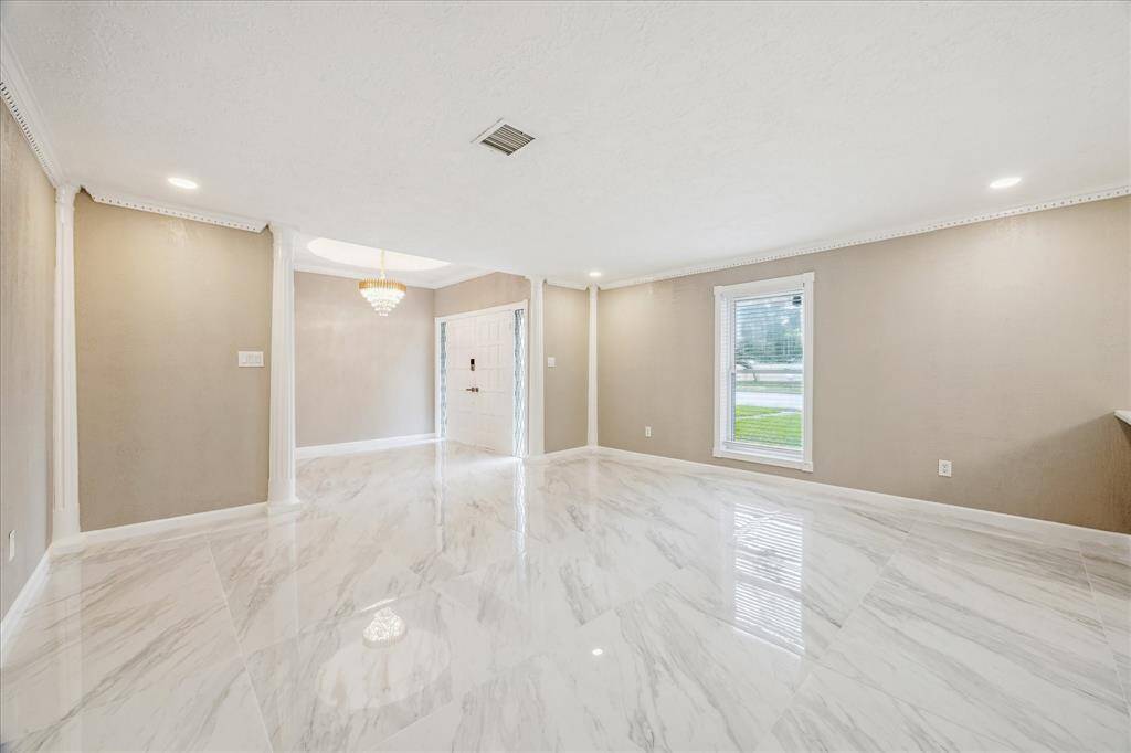 FORMAL DINING AND LIVING ROOM FACING THE FRONT DOOR