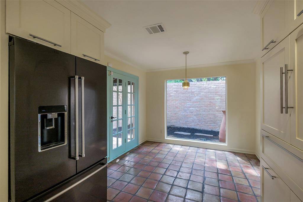View of the intimate kitchen dining area that overlooks a private patio/garden. Just step outside those doors to enjoy your morning coffee.