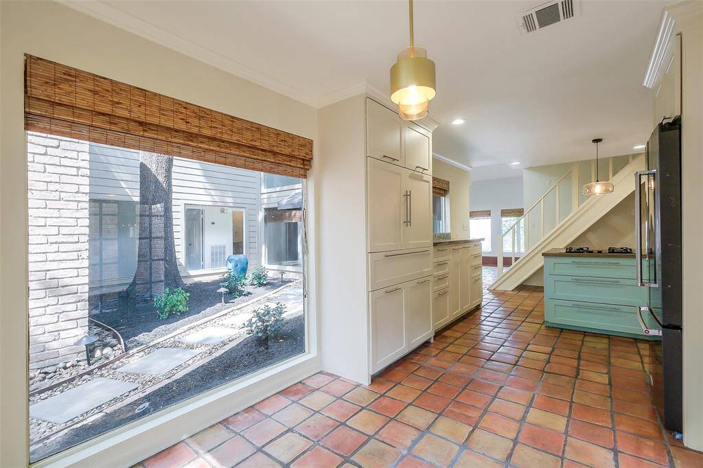 View of the intimate kitchen dining area that overlooks a private patio/garden.