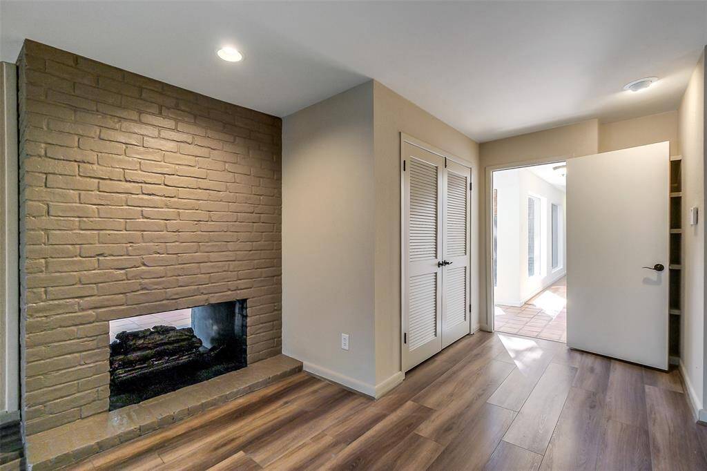 View of the primary bedroom fireplace and the door that leads to the cedar closet.
