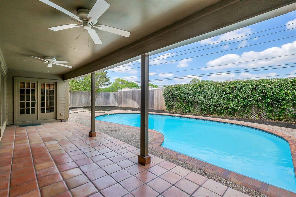 Spacious covered patio overlooking the pool.