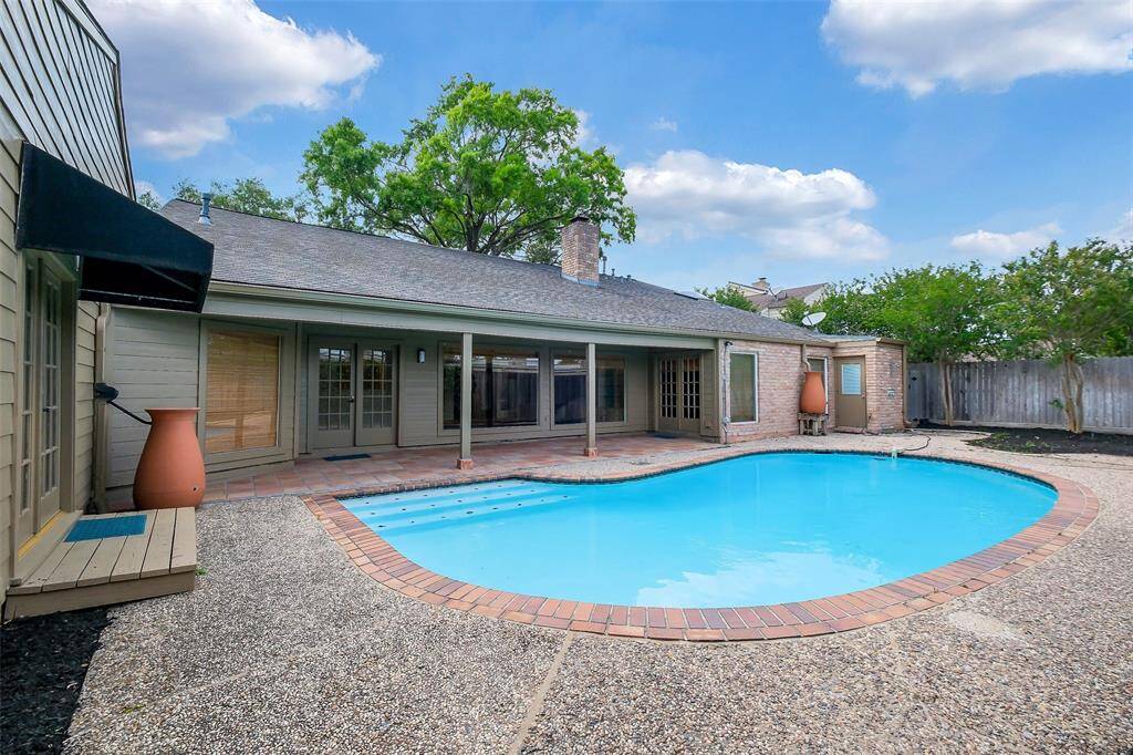 Spacious covered patio overlooking the pool.