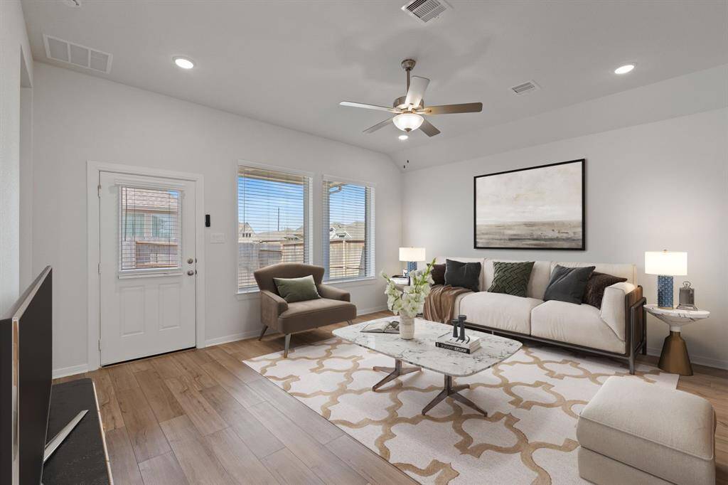 Family room open to the kitchen. (Virtually Staged)