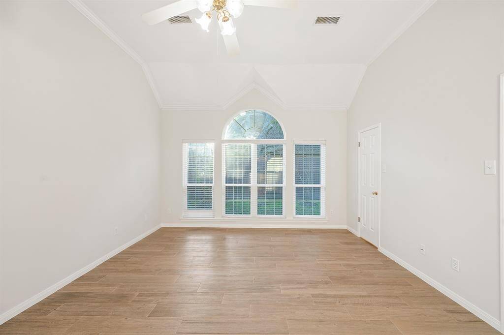 What a wonderful place to come home to, this stunning master suite greets you with plush carpet, high ceiling, crown molding, ceiling fan, wall of windows allowing in natural light brightening up this spacious master bedroom.