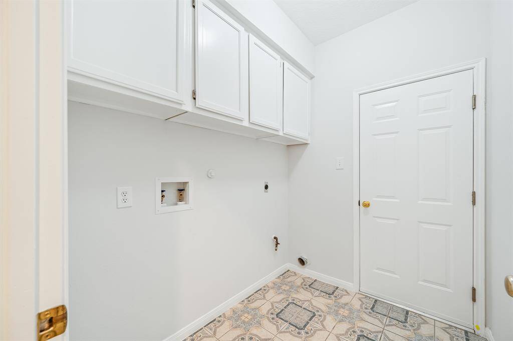 Clean up is a breeze in this laundry and plenty of storage
