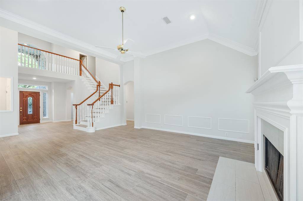 Welcome your guests into this elegant foyer! From the beautiful front doors to the high ceilings to the lovely wood look tile flooring, you can sense the charm and elegance of this home from the first look.