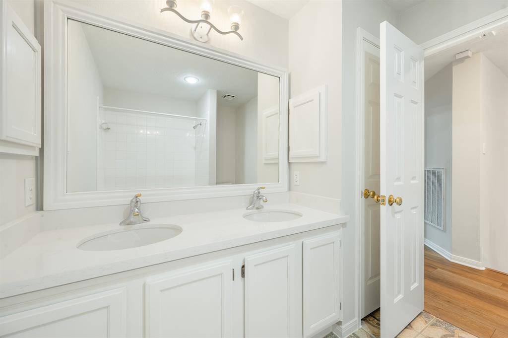 Secondary bathroom , shower/tub combo, large mirror, tile floors, plenty of space to accommodate any visiting family or guests.