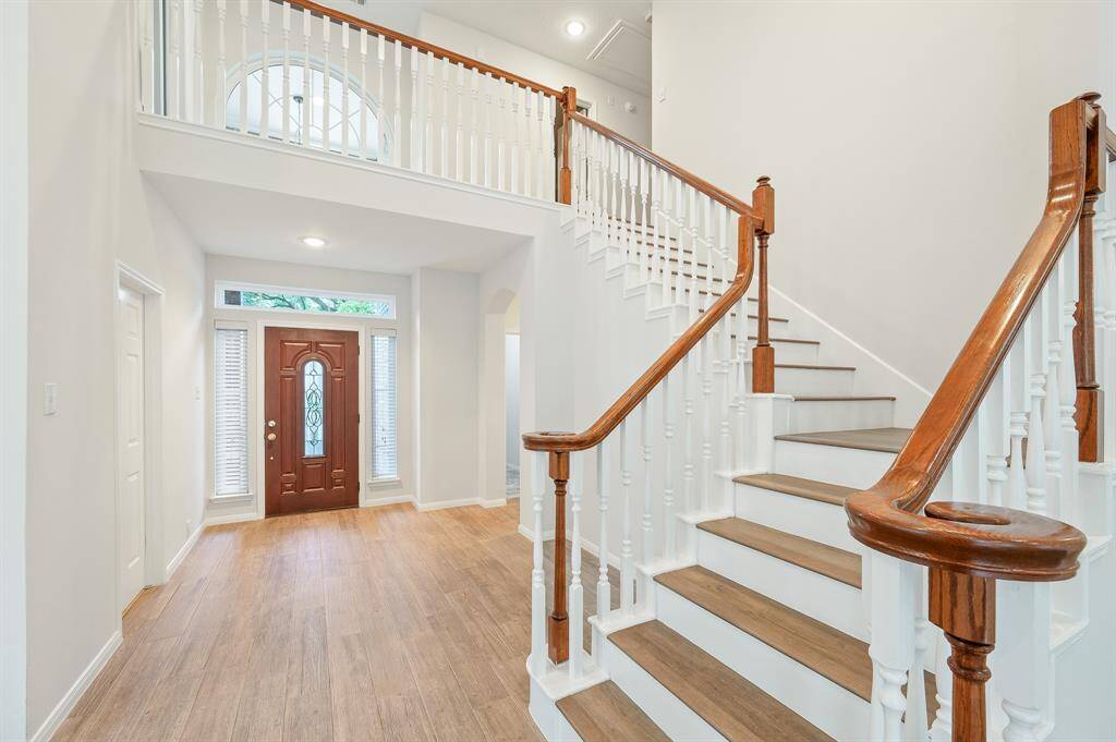 Stunning two story main living area providing the finest in open concept living.  The space is thoroughly washed with sunlight from the wall of windows overlooking the back yard