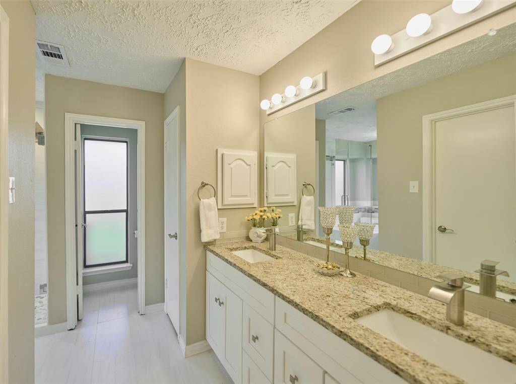 Primary Suite with Recent Granite, Soft Close Cabinets, Sinks, Faucets, Tile Flooring, Tub & Shower and dimmable Lighting! Includes a Toilet Room, Linen Closet and Walk-In Closet.