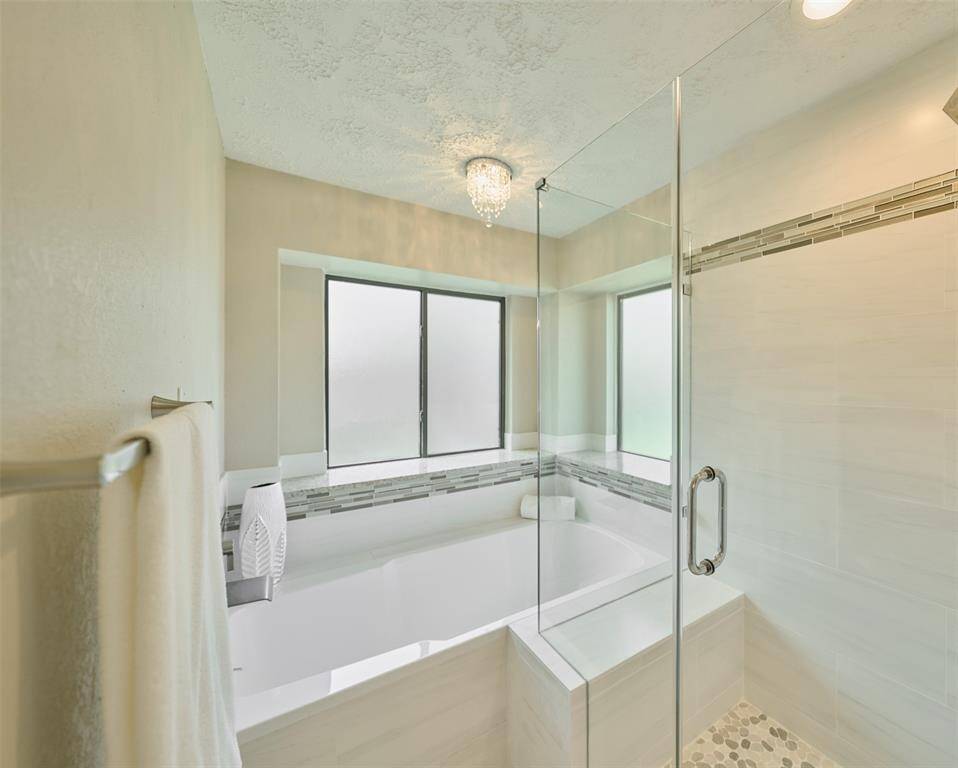 Enjoy hours of Relaxation in this recently installed Tub, Shower, Tile, Windows, and dimmable Chandelier!