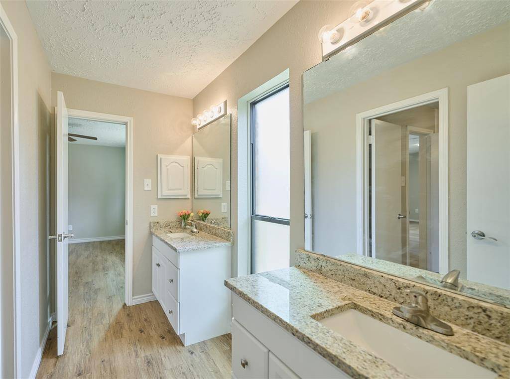 Jack n Jill Bath with new Cabinetry, Sinks, Granite, and Fixtures.