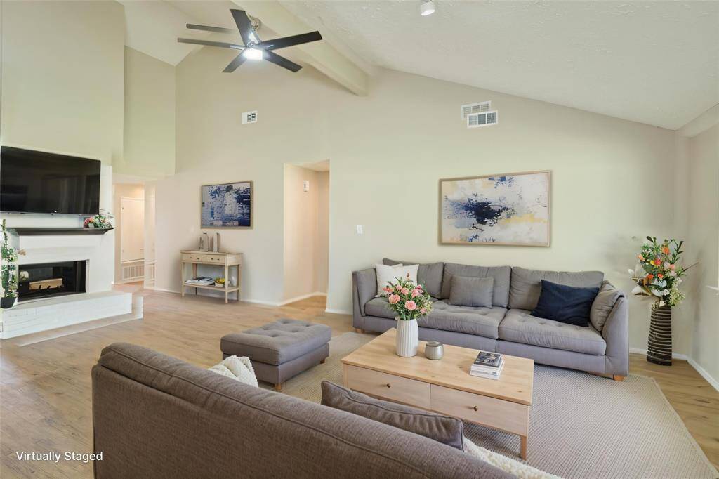 Living Room is Spacious and Open! Offers Remote Controlled Ceiling Fan, Spot Lighting, and opens to Dining and Kitchen.