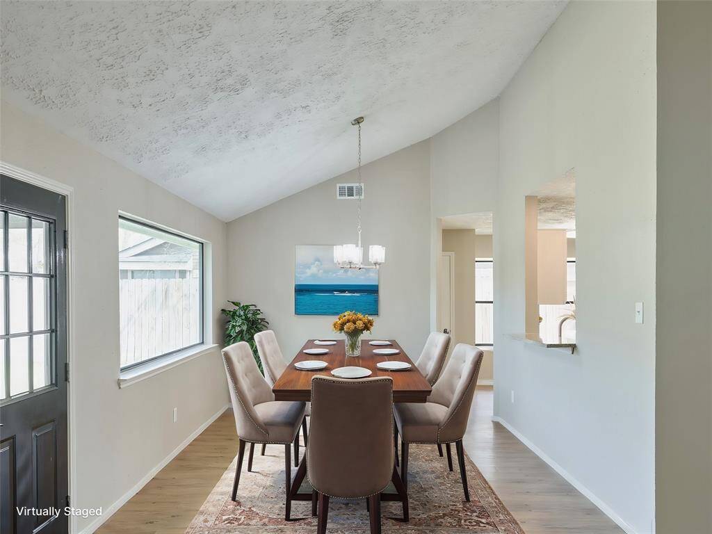 Dining opens to Living Room, Kitchen and Breakfast area with Fabulous views of the Backyard.  Lighting is Dimmable!