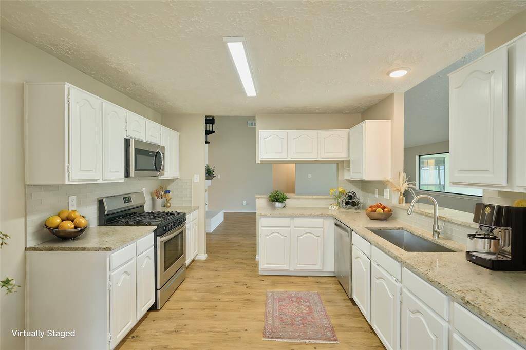 Kitchen with SS Appliances, including new Dishwasher and Microwave.  Lighting has changeable tones.