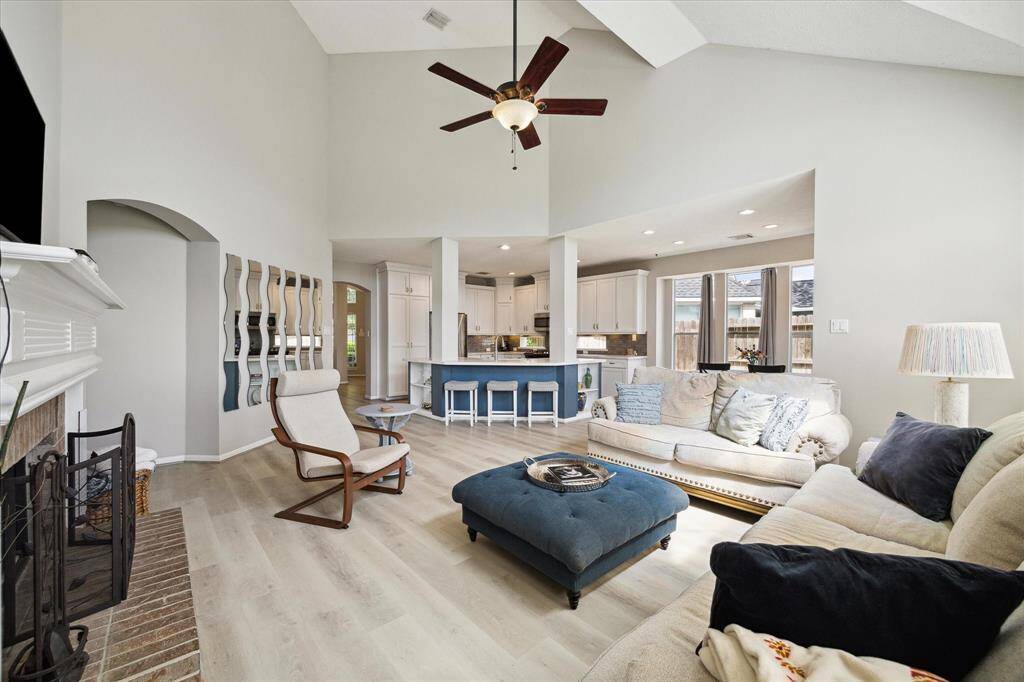 Spacious open-concept living area seamlessly flows into a modern kitchen, perfect for entertaining.