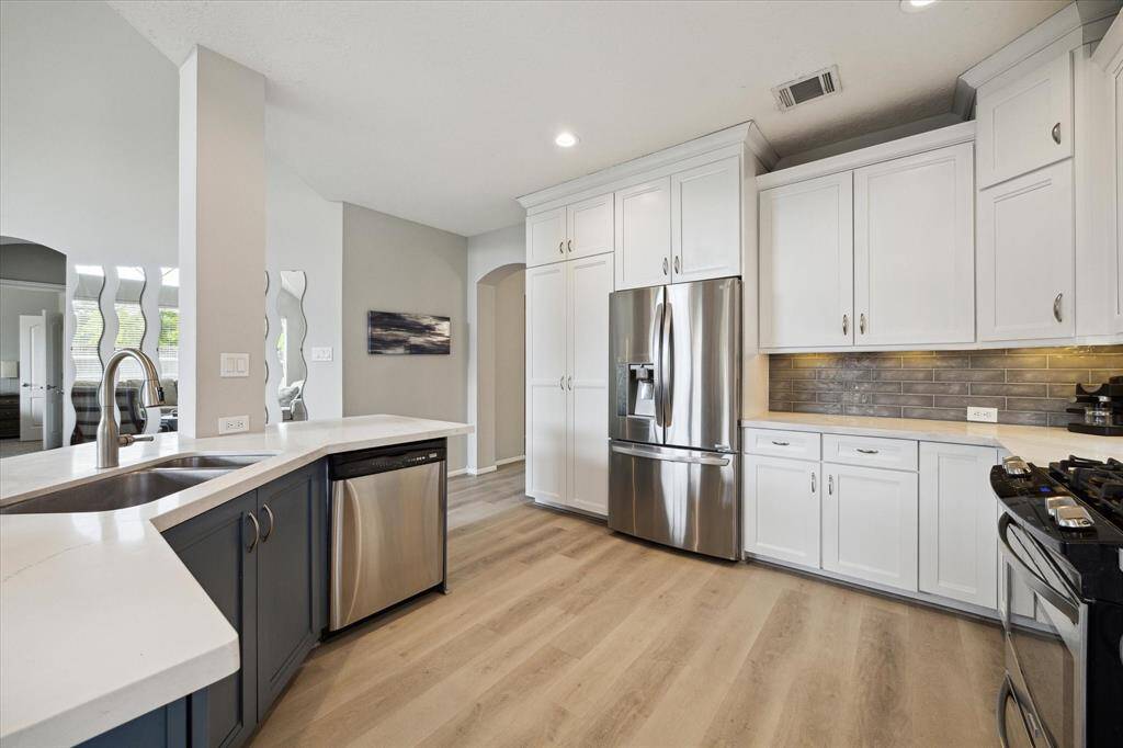 Abundant storage with updated cabinets featuring soft-close and pot drawers.