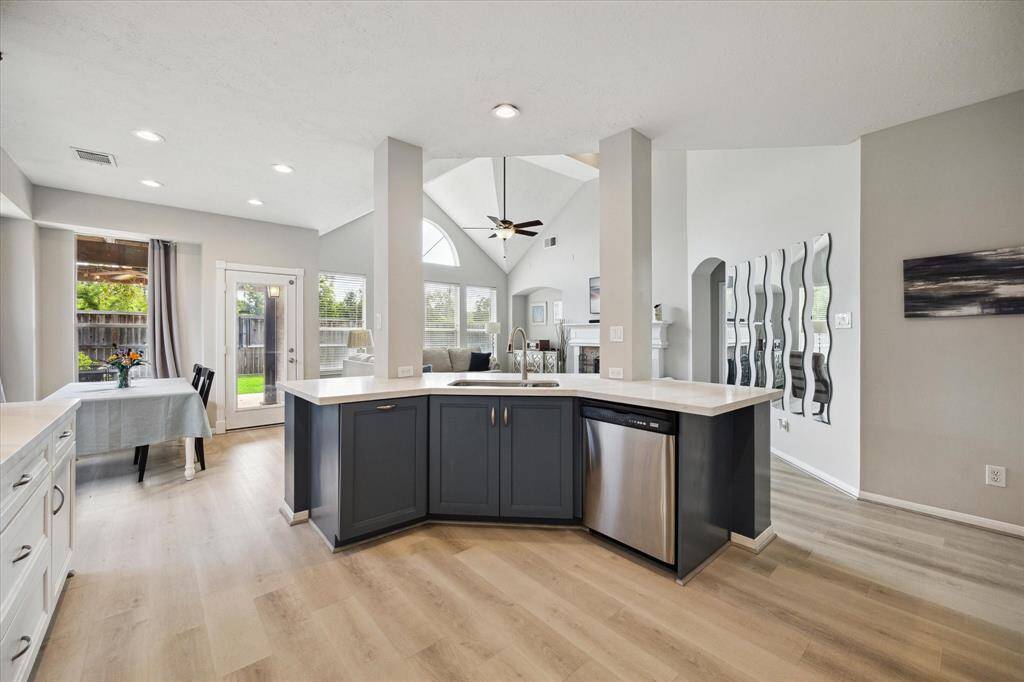 This spacious island offers additional seating, ample counter space, and a built-in trash solution.