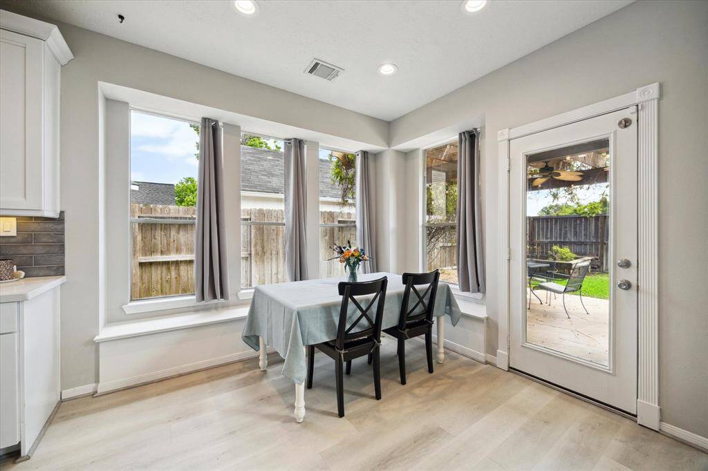Enjoy breakfast on a cozy built-in bench, surrounded by windows with serene backyard views.