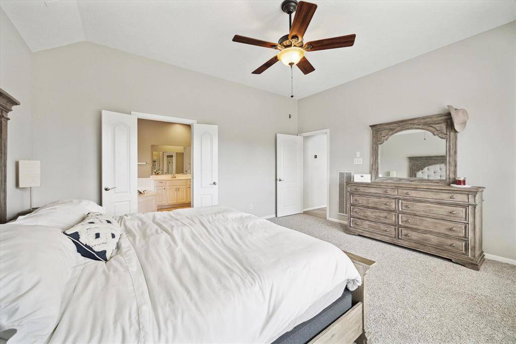 Spacious primary bedroom with ensuite bath, featuring new carpet and fresh paint.