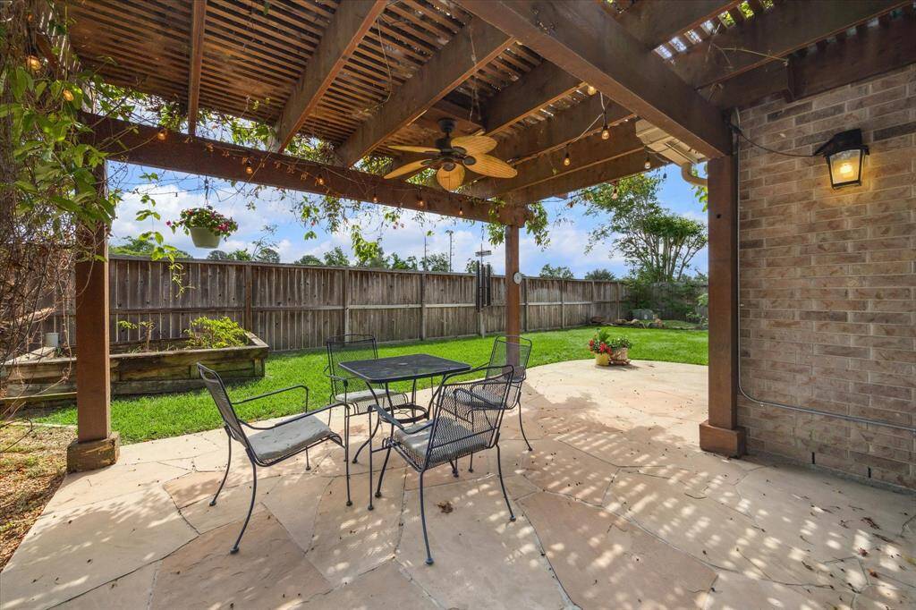 Enjoy the privacy of a serene, shaded patio with a pergola adorned in blooming vines and no rear neighbors.