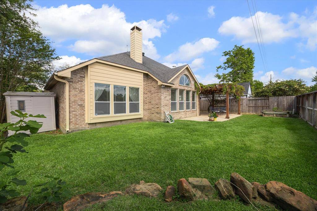 Expansive yard with a convenient storage shed.
