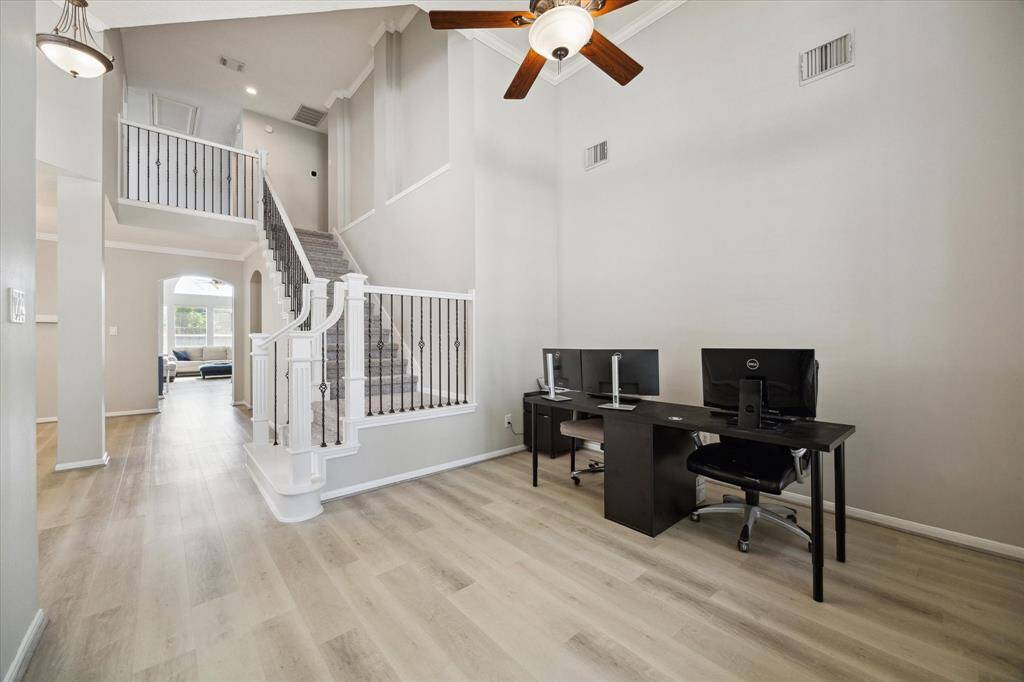Just off the entry is an expansive flex space for a home office, formal seating area, piano room etc.